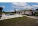 Back exterior view of the home showcasing a pool and hot tub at 11320 Montevista Rd, Clermont, FL 34711
