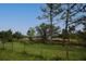 Rural property with a mix of trees and pasture enclosed by a wire fence at 11320 Montevista Rd, Clermont, FL 34711