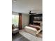 Bedroom boasts hardwood flooring, ceiling fan, and a window bringing in natural light at 12850 Lexington Summit St, Orlando, FL 32828