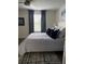 Bright bedroom features a ceiling fan, and large window with coverings for privacy at 12850 Lexington Summit St, Orlando, FL 32828