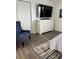 Bedroom with hard floors, decorative rug, closet, dresser and stylish blue chair at 12850 Lexington Summit St, Orlando, FL 32828