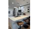 Modern kitchen boasting white cabinets, stainless steel appliances, and a spacious island with bar stools at 12850 Lexington Summit St, Orlando, FL 32828