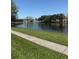 Scenic view of a community pond with a fountain, surrounded by lush greenery at 12850 Lexington Summit St, Orlando, FL 32828