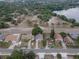 An aerial view of a neighborhood near a lake, showcasing the residential homes and mature trees at 13 N Observatory Dr, Orlando, FL 32835
