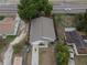 Aerial view of a house with a gray roof, well-maintained yard, and a long driveway at 13 N Observatory Dr, Orlando, FL 32835