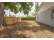 Large backyard with a wood fence and mature trees, providing privacy and shade at 13 N Observatory Dr, Orlando, FL 32835