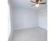 Inviting bedroom featuring ceiling fan, new tile flooring and closet at 13 N Observatory Dr, Orlando, FL 32835