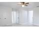 Bright bedroom featuring updated ceiling fan, new tile floor, and white doors at 13 N Observatory Dr, Orlando, FL 32835