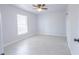 Light filled bedroom with tile flooring, ceiling fan and a bright window at 13 N Observatory Dr, Orlando, FL 32835
