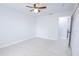 Bright bedroom with neutral walls, a ceiling fan, and a hallway that leads into another room at 13 N Observatory Dr, Orlando, FL 32835