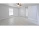 Bright bedroom with new tile flooring, updated ceiling fan and large window at 13 N Observatory Dr, Orlando, FL 32835