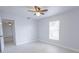Relaxing bedroom featuring ceiling fan, window, and new tile flooring at 13 N Observatory Dr, Orlando, FL 32835