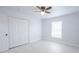 Bright bedroom featuring neutral walls, bright tile floors, and a ceiling fan for a modern feel at 13 N Observatory Dr, Orlando, FL 32835