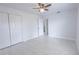 Open bedroom featuring updated ceiling fan, new tile floor and closet at 13 N Observatory Dr, Orlando, FL 32835