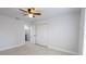 This bedroom features neutral walls, bright tile floors, and a ceiling fan for a clean and modern aesthetic at 13 N Observatory Dr, Orlando, FL 32835