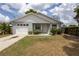 Charming single-story home featuring a one-car garage and a well-maintained front yard at 13 N Observatory Dr, Orlando, FL 32835