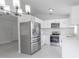 Modern kitchen with stainless steel appliances and white cabinetry at 13 N Observatory Dr, Orlando, FL 32835