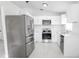 Bright kitchen featuring stainless steel appliances and white cabinets, offering a clean and modern design at 13 N Observatory Dr, Orlando, FL 32835