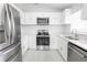 Modern kitchen with stainless steel appliances, ample counter space, and bright white cabinetry at 13 N Observatory Dr, Orlando, FL 32835