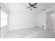 Spacious living room with new flooring, white walls, and a modern ceiling fan at 13 N Observatory Dr, Orlando, FL 32835
