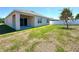 Open backyard featuring lawn, planting area, and white fencing at 133 Grove Branch Rd, Winter Haven, FL 33880