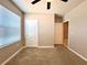 Neutral bedroom with plush carpeting, window, and two doors at 133 Grove Branch Rd, Winter Haven, FL 33880