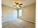 Comfortable bedroom with ceiling fan, natural light, and plush carpeting at 133 Grove Branch Rd, Winter Haven, FL 33880