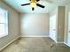 Bedroom with a ceiling fan, a window with blinds, and carpeted flooring at 133 Grove Branch Rd, Winter Haven, FL 33880