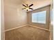Cozy bedroom featuring neutral walls, carpet, ceiling fan, and window with natural light at 133 Grove Branch Rd, Winter Haven, FL 33880