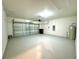 Spacious garage with a painted floor, ample lighting, and an automatic door at 133 Grove Branch Rd, Winter Haven, FL 33880
