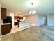Open concept space featuring a kitchen flowing into a living area with plush carpeting at 133 Grove Branch Rd, Winter Haven, FL 33880