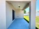 Covered patio featuring blue concrete flooring and neutral wall color at 133 Grove Branch Rd, Winter Haven, FL 33880