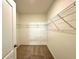 Walk-in closet with carpeted floor and wire rack shelving system for optimal organization at 133 Grove Branch Rd, Winter Haven, FL 33880
