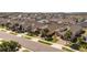 Wide aerial shot of a residential neighborhood showcasing uniform homes with manicured lawns and palm trees at 1335 Zeek Ridge St, Clermont, FL 34715