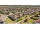Community aerial view of a neighborhood featuring single-Gathering homes with manicured lawns, fenced yards, and well-maintained streets at 1335 Zeek Ridge St, Clermont, FL 34715