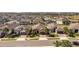 Aerial view of a well-maintained neighborhood with neatly arranged houses, lush lawns, and palm tree accents at 1335 Zeek Ridge St, Clermont, FL 34715