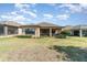 The backyard showcases a well-maintained lawn, screened patio, and thoughtfully designed landscaping, ideal for outdoor enjoyment at 1335 Zeek Ridge St, Clermont, FL 34715