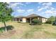 Expansive backyard featuring lush green lawn, screened lanai, and beautifully manicured landscaping, creating a private oasis at 1335 Zeek Ridge St, Clermont, FL 34715