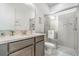 Elegant bathroom with glass shower, white vanity, and decorative artwork on the walls at 1335 Zeek Ridge St, Clermont, FL 34715