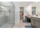 Bathroom featuring double sinks, glass shower, and access to a large walk-in closet at 1335 Zeek Ridge St, Clermont, FL 34715