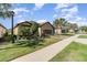 Well-kept single-Gathering home with beautiful landscaping, palm trees, and a brown two-car garage at 1335 Zeek Ridge St, Clermont, FL 34715