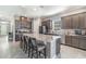 Kitchen with a large island, granite countertops, stainless steel appliances, and tile flooring at 1335 Zeek Ridge St, Clermont, FL 34715