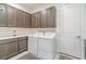 Well-organized laundry room featuring upper cabinets, countertop space, and modern appliances at 1335 Zeek Ridge St, Clermont, FL 34715