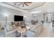 Open-concept living room and dining area with tile floors, neutral walls, and modern furniture at 1335 Zeek Ridge St, Clermont, FL 34715