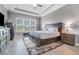 Main bedroom featuring a tray ceiling, neutral walls, and a large window with blinds at 1335 Zeek Ridge St, Clermont, FL 34715