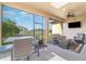 Outdoor patio with screened windows, dining area, and comfortable lounge seating at 1335 Zeek Ridge St, Clermont, FL 34715