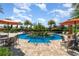 Another view of the community's inviting circular pool area, featuring comfortable seating and lush tropical surroundings at 1335 Zeek Ridge St, Clermont, FL 34715