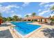 Sparkling community pool, surrounded by lounge chairs, tropical landscaping, and umbrellas, perfect for relaxation and recreation at 1335 Zeek Ridge St, Clermont, FL 34715