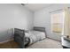 Cozy bedroom featuring neutral walls, carpeted floor, and a comfortable bed by a bright window at 14556 Unbridled Dr, Orlando, FL 32826