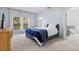 Cozy bedroom featuring plush carpet, ensuite bathroom and large windows with natural light at 14556 Unbridled Dr, Orlando, FL 32826